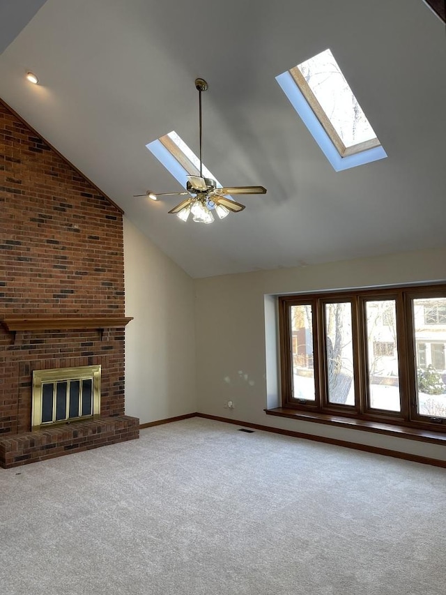 unfurnished living room with carpet, a fireplace, a ceiling fan, high vaulted ceiling, and baseboards