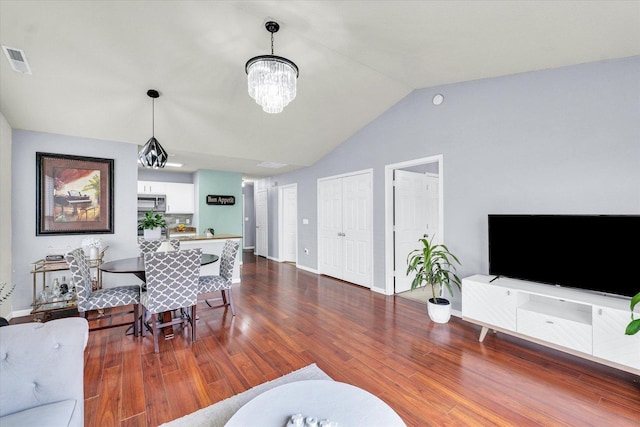 living area featuring visible vents, baseboards, lofted ceiling, an inviting chandelier, and dark wood-style floors