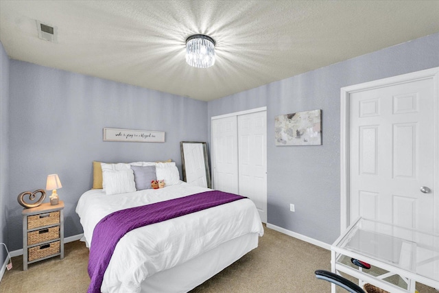 carpeted bedroom with a closet, visible vents, and baseboards