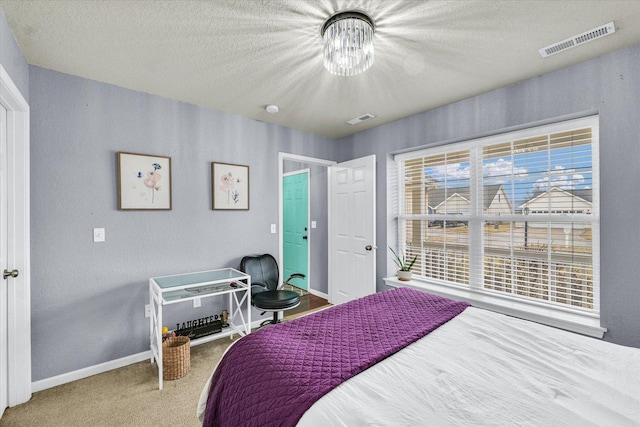 bedroom featuring visible vents, baseboards, a notable chandelier, and carpet flooring