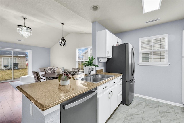 kitchen featuring visible vents, a sink, stainless steel appliances, pendant lighting, and marble finish floor