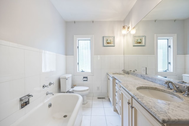 full bathroom featuring a bathtub, tile patterned flooring, a sink, and toilet