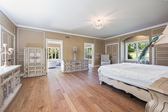 bedroom featuring visible vents, crown molding, and light wood finished floors