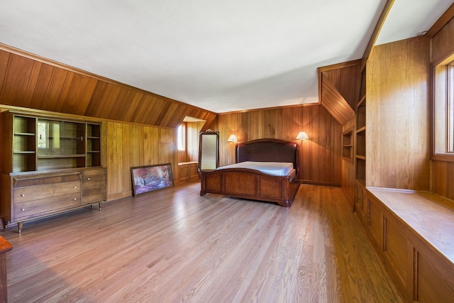 unfurnished bedroom featuring wood walls and wood finished floors