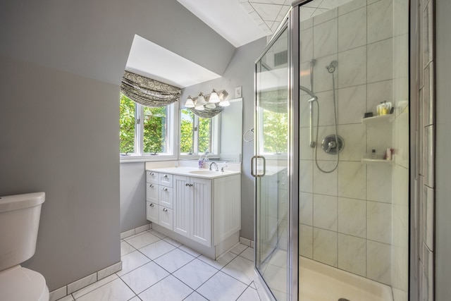 full bathroom with toilet, a shower stall, vanity, tile patterned flooring, and baseboards