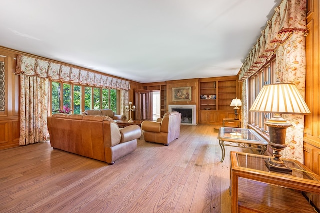 living room with light wood-type flooring and a fireplace