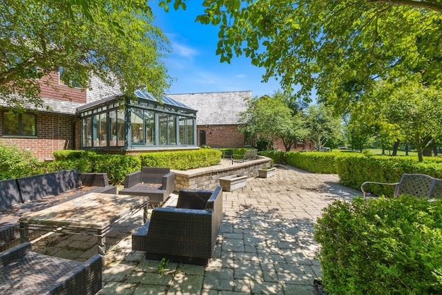 view of patio featuring a sunroom