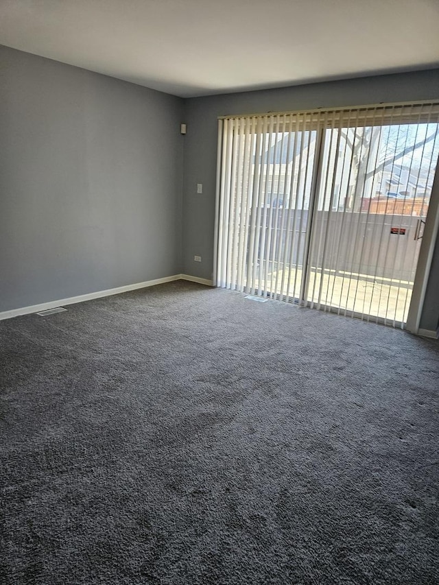 spare room with carpet floors and baseboards