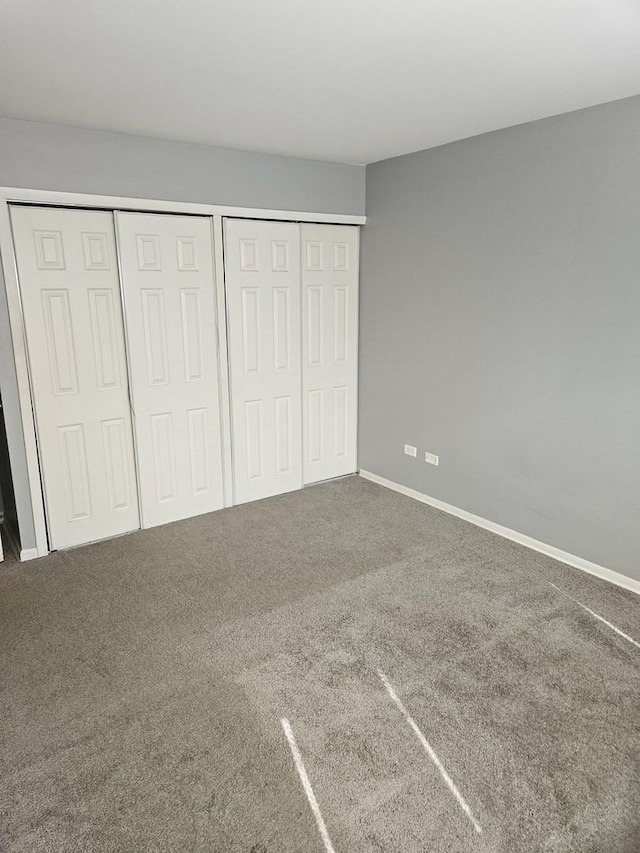 unfurnished bedroom with carpet and baseboards