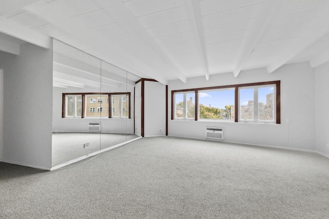 carpeted spare room with beamed ceiling, a wall mounted AC, and baseboards