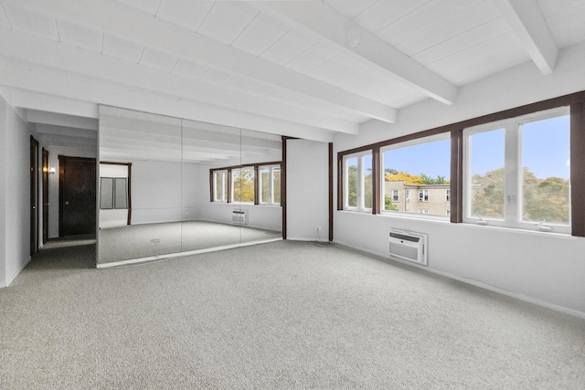 carpeted empty room with a wall mounted air conditioner, beam ceiling, and baseboards