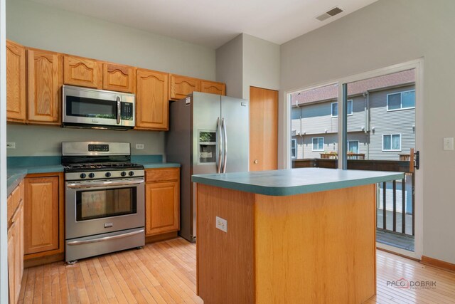 1061 Chadwick Dr, Grayslake, IL 60030 - kitchen with appliances with stainless steel finishes, light wood-style floors, and a center island