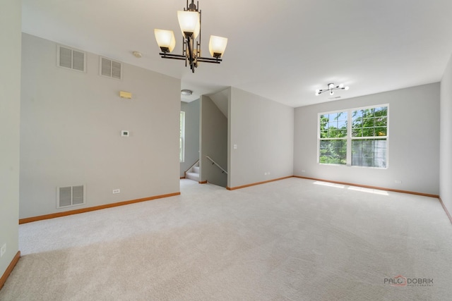 1061 Chadwick Dr, Grayslake, IL 60030 - carpeted spare room featuring a chandelier and stairs