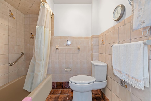 full bathroom with shower / tub combo, a wainscoted wall, tile walls, and toilet