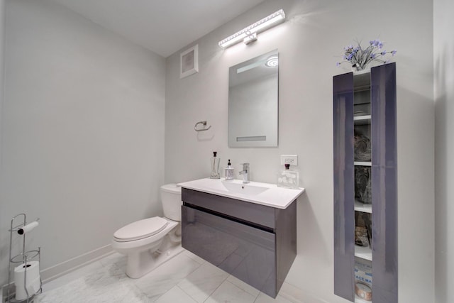 half bathroom with marble finish floor, visible vents, toilet, vanity, and baseboards