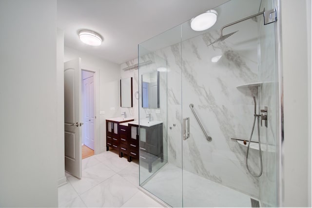 full bath featuring marble finish floor, a marble finish shower, and vanity