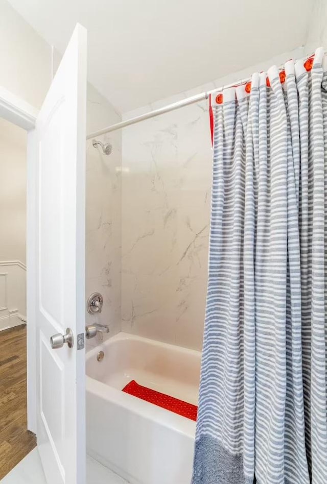 full bath with shower / tub combo and wood finished floors