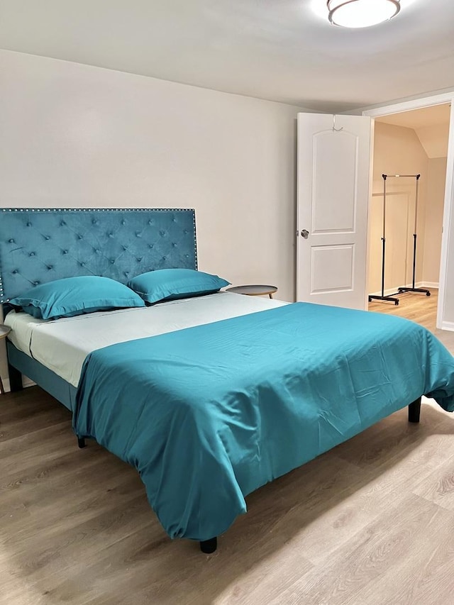 bedroom with wood finished floors