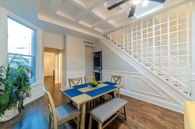 dining area featuring coffered ceiling, wood finished floors, visible vents, a ceiling fan, and stairway