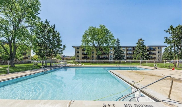 pool with fence and a patio