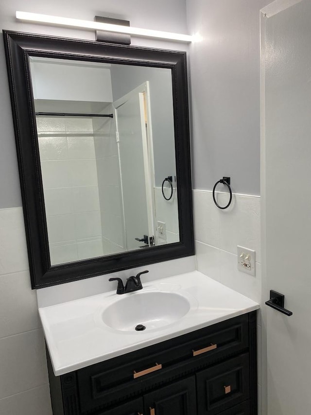 bathroom featuring tile walls and vanity