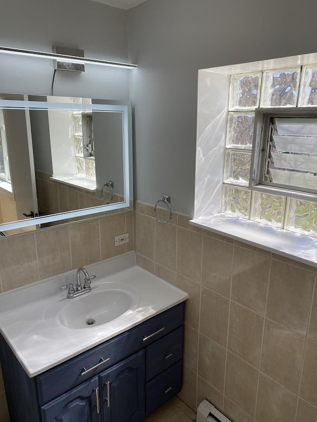 bathroom featuring vanity and tile walls