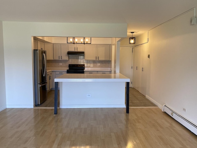 kitchen with freestanding refrigerator, black / electric stove, baseboard heating, light countertops, and under cabinet range hood