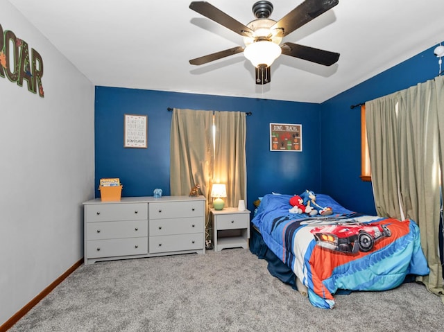 carpeted bedroom featuring baseboards and ceiling fan