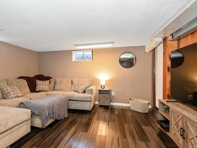 living area featuring baseboards and dark wood-type flooring