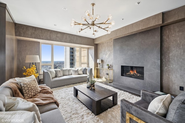 living room with a large fireplace and a chandelier