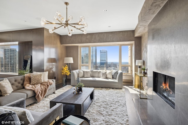 living room with a premium fireplace, a view of city, and an inviting chandelier