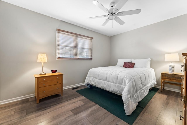 bedroom featuring baseboards, visible vents, and wood finished floors