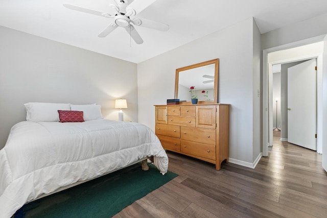 bedroom featuring a ceiling fan, baseboards, and wood finished floors