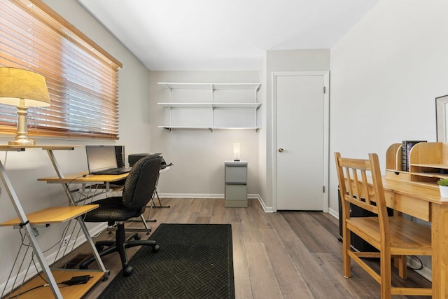 office area with baseboards and wood finished floors