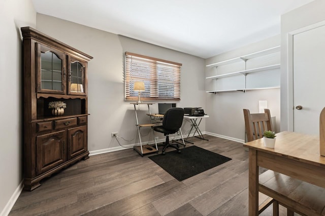 home office with baseboards and wood finished floors