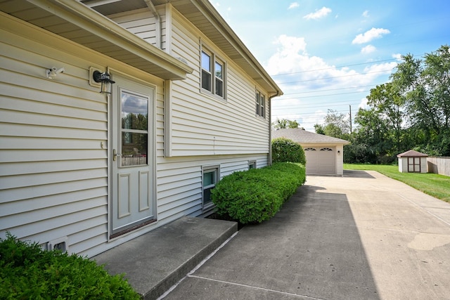 view of side of property with an outbuilding and a detached garage