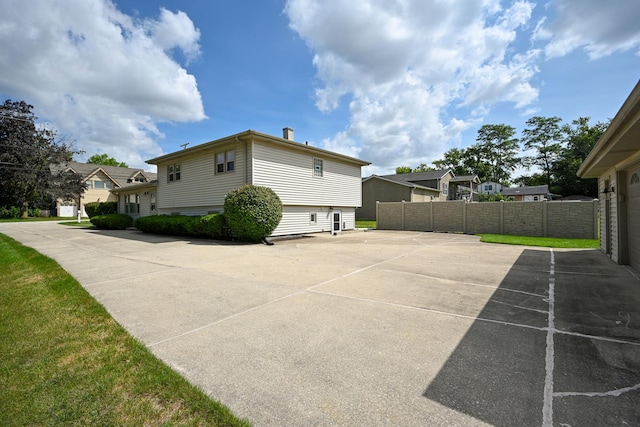 view of property exterior with fence