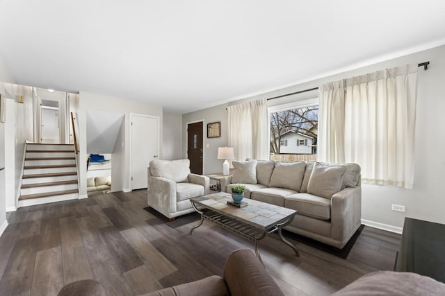 living area featuring stairs, baseboards, and dark wood-style flooring