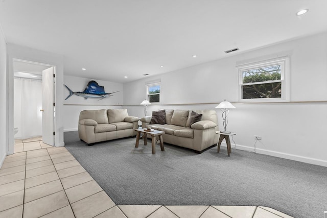 living room featuring light tile patterned floors, visible vents, baseboards, light colored carpet, and recessed lighting