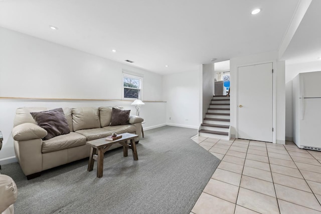 living room with light tile patterned floors, recessed lighting, visible vents, baseboards, and stairs