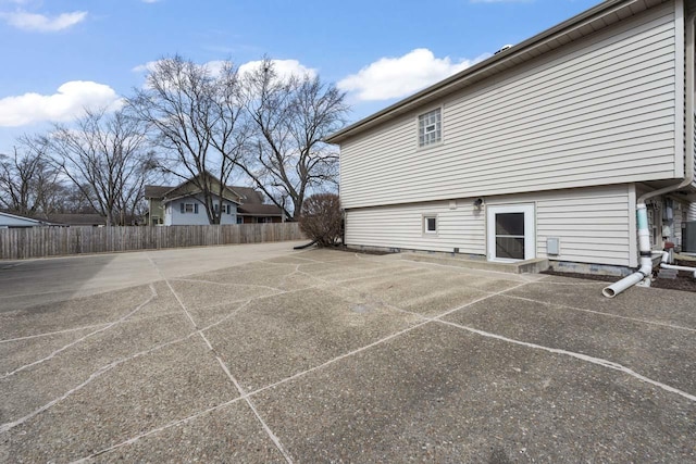 view of side of property featuring fence