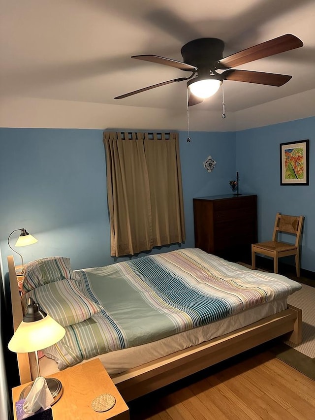 bedroom featuring a ceiling fan and wood finished floors