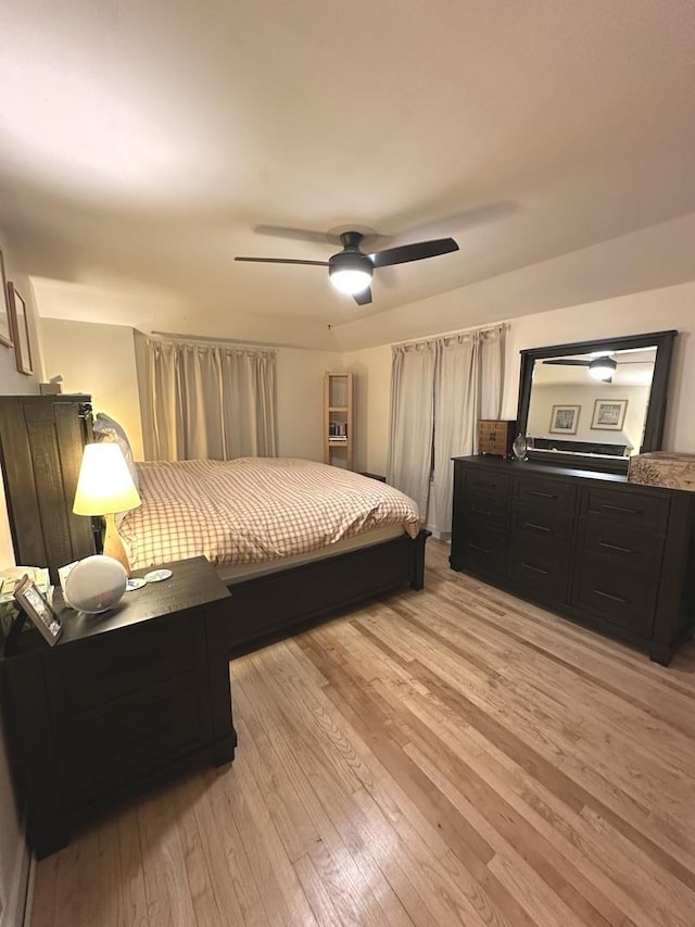 bedroom with light wood-style floors and a ceiling fan