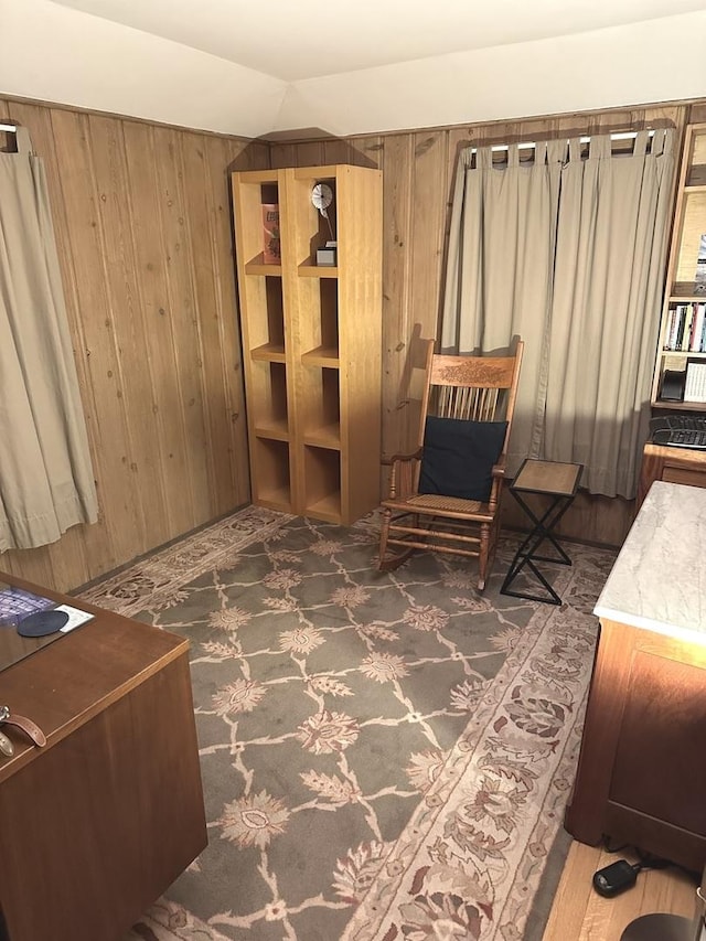 living area featuring wooden walls and vaulted ceiling