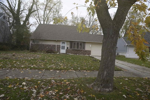 view of front facade featuring an attached garage, concrete driveway, stone siding, roof with shingles, and a front lawn