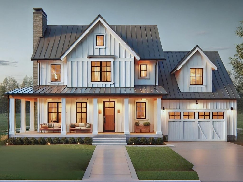 modern farmhouse featuring board and batten siding, a standing seam roof, metal roof, and concrete driveway