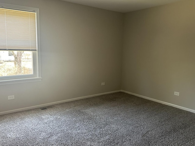 carpeted empty room with baseboards