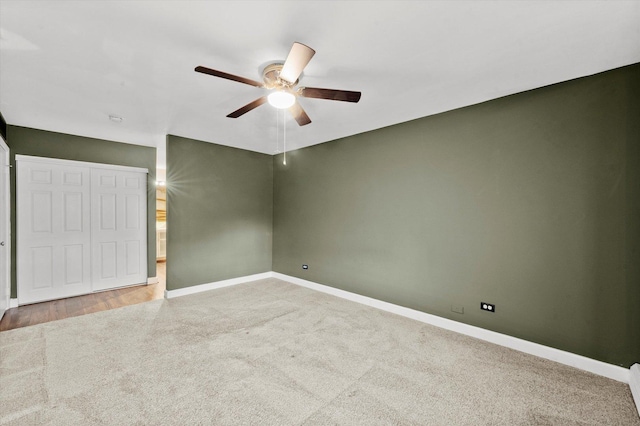 unfurnished bedroom featuring a ceiling fan, carpet, a closet, and baseboards