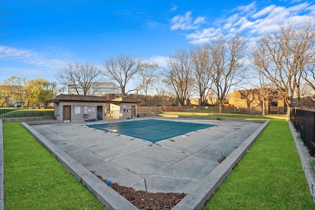 pool featuring a patio, a lawn, and fence