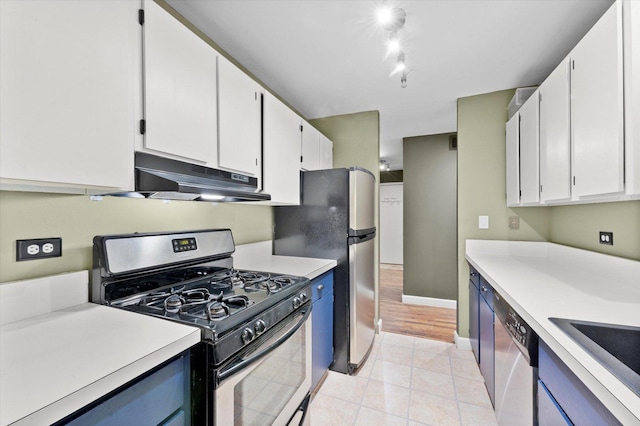 kitchen with stainless steel appliances, white cabinets, light countertops, and under cabinet range hood